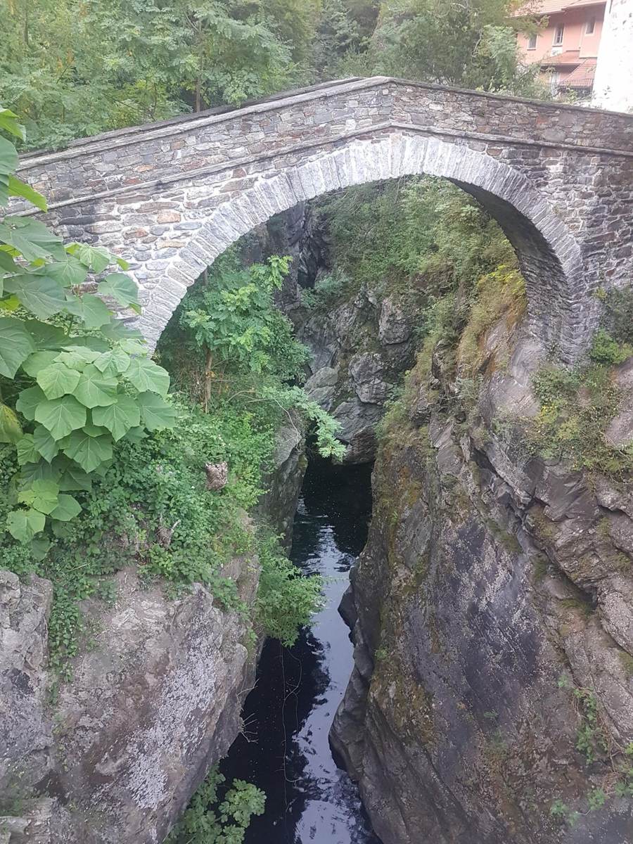 Old stone bridge over the river gorge in the Cannobino Valley