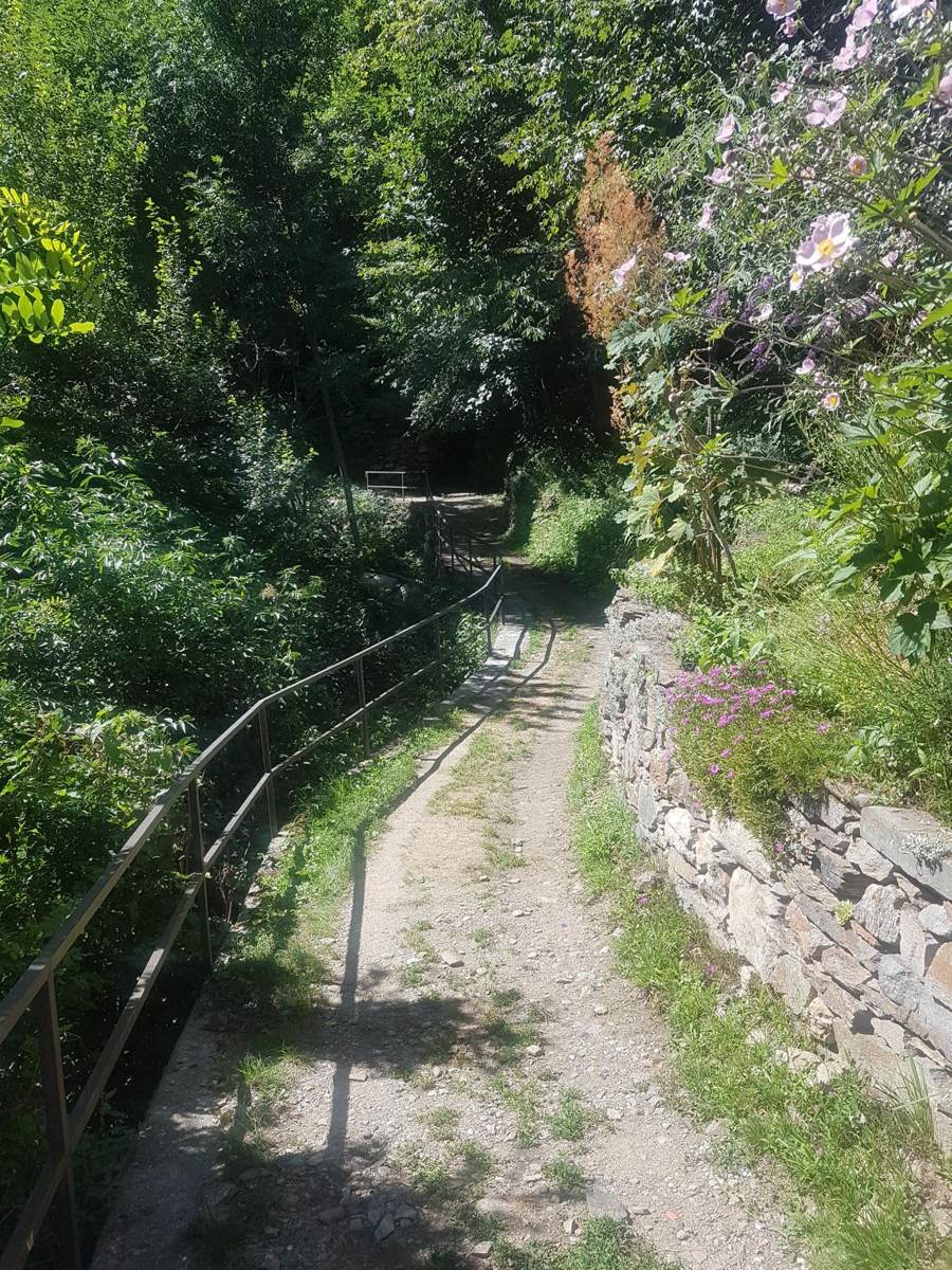Narrow gravel track running along a stone wall in the hills above Cannobio
