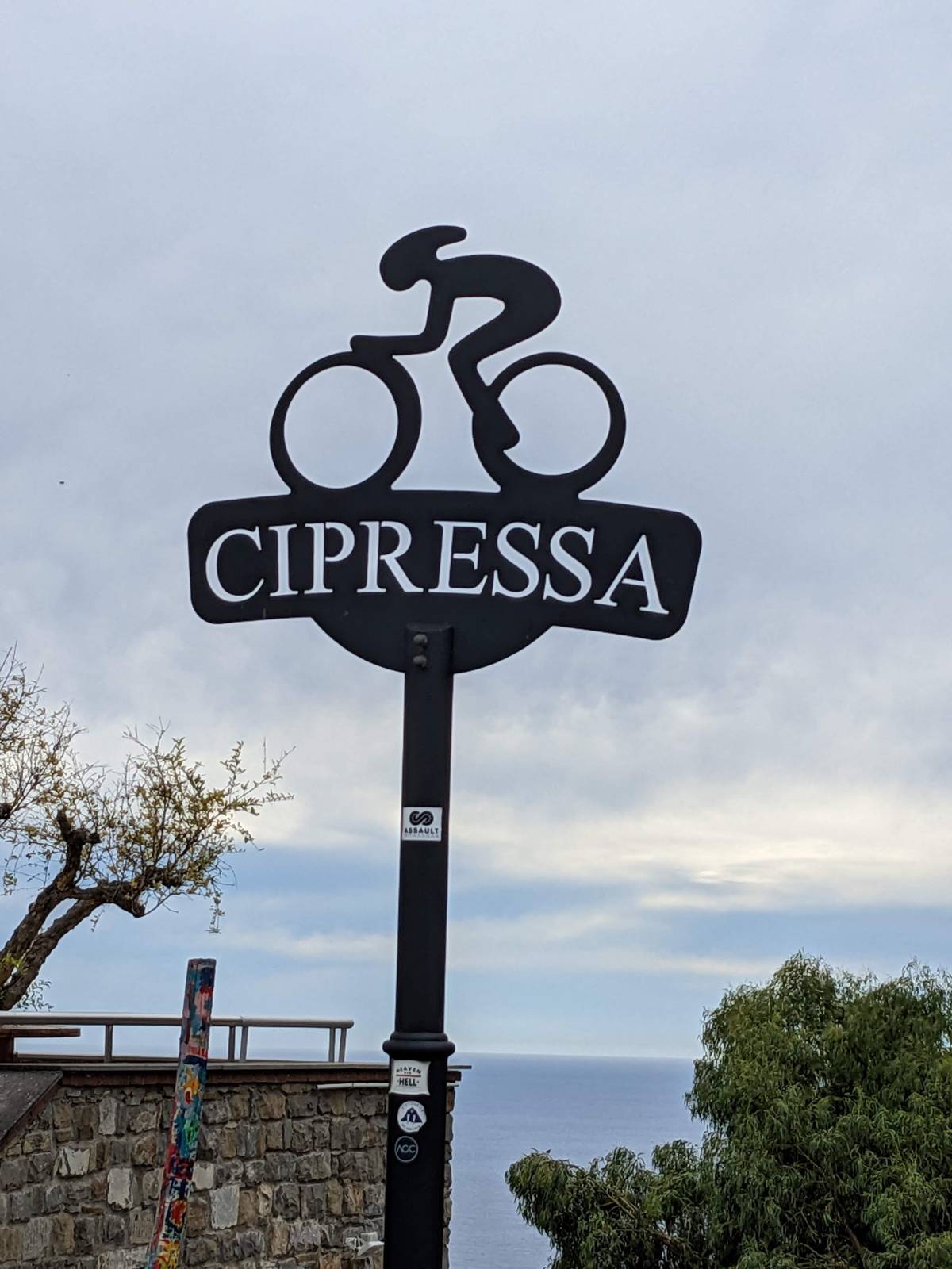 A road sign reading CIPRESSA with a cycling route marker, Liguria, Italy