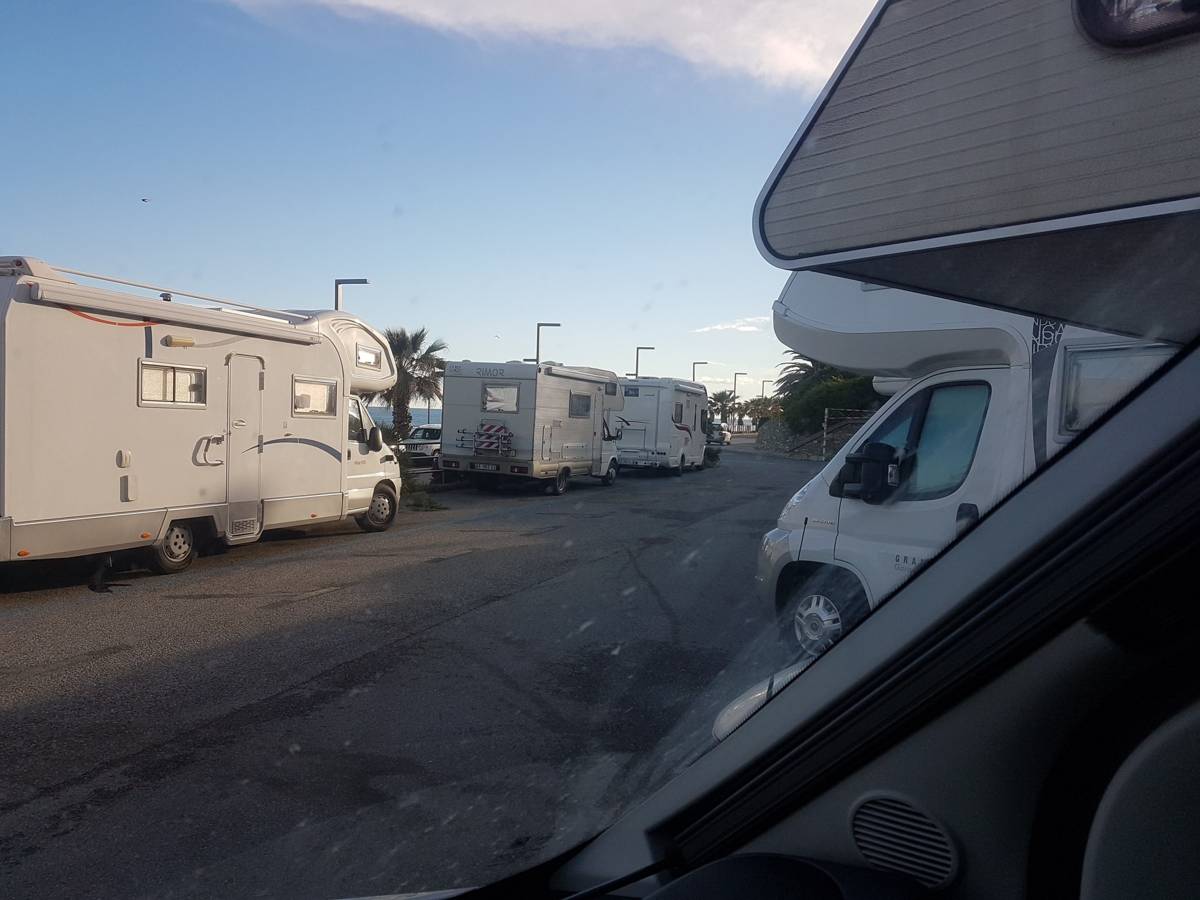 Motorhomes parked at a coastal aire near Cipressa, Liguria