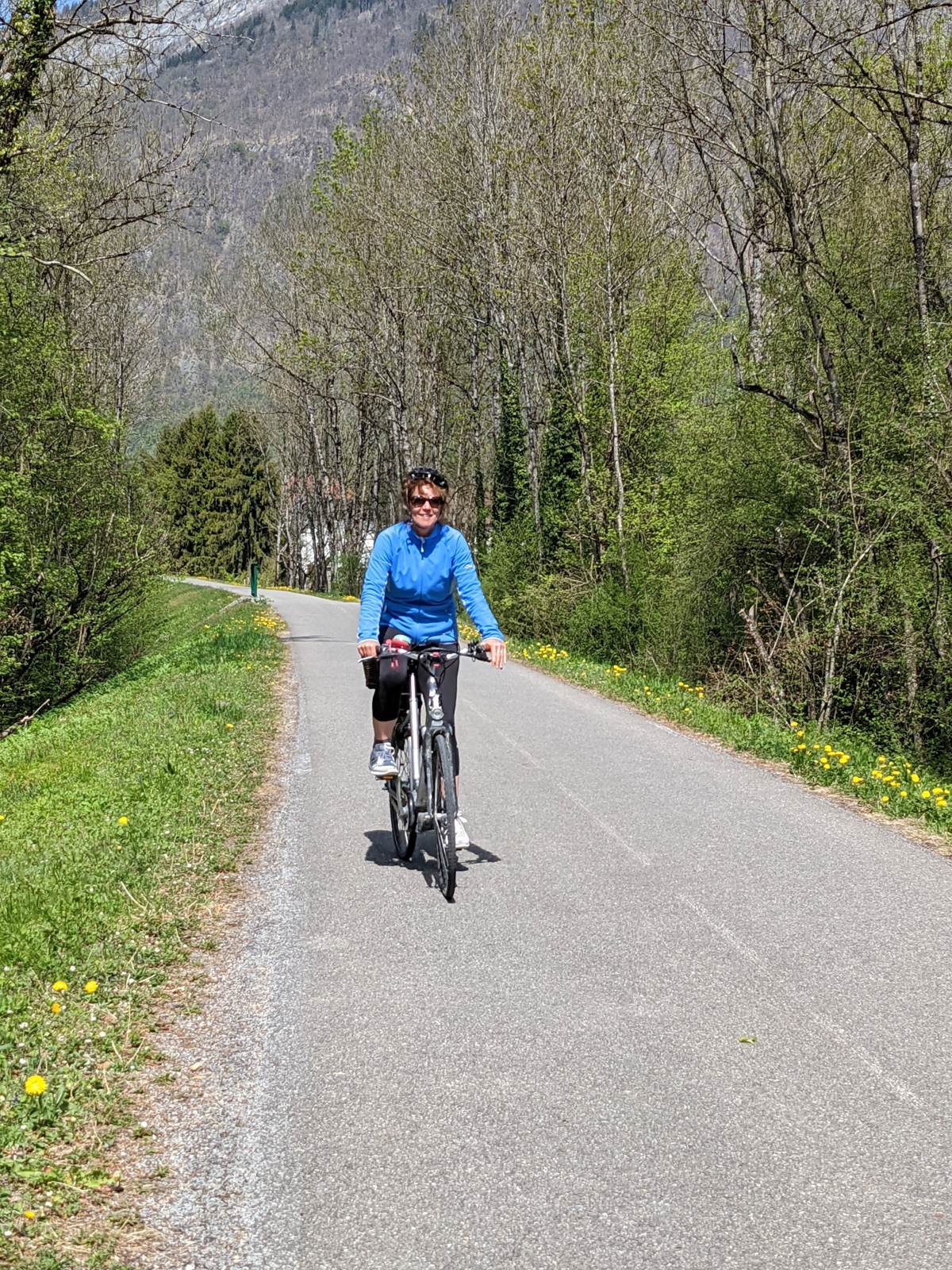 Kevin's wife cycling a flat valley path near Beaufort in the French Alps