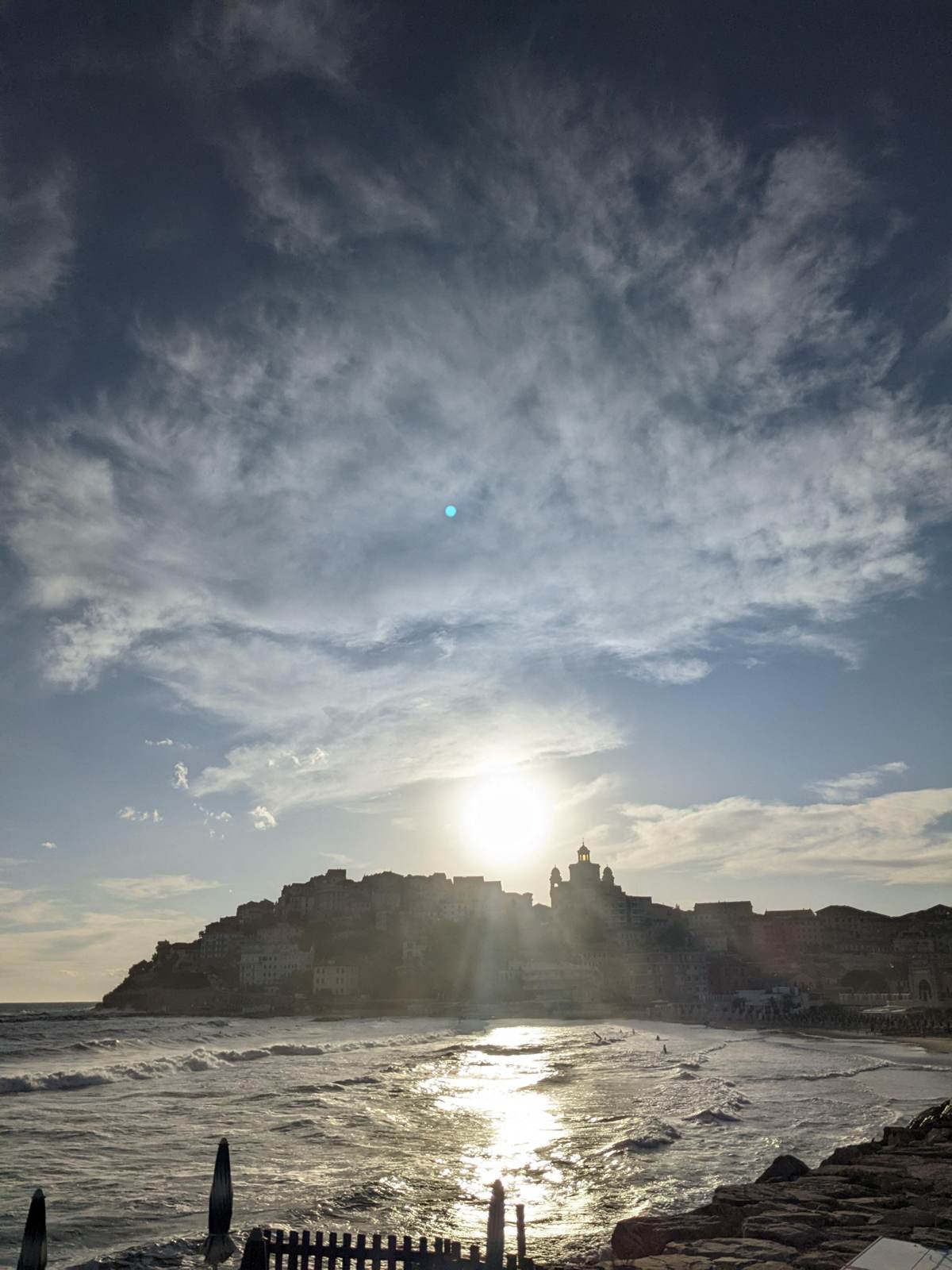 Sunset over Porto Maurizio harbour with the old town silhouette, Imperia