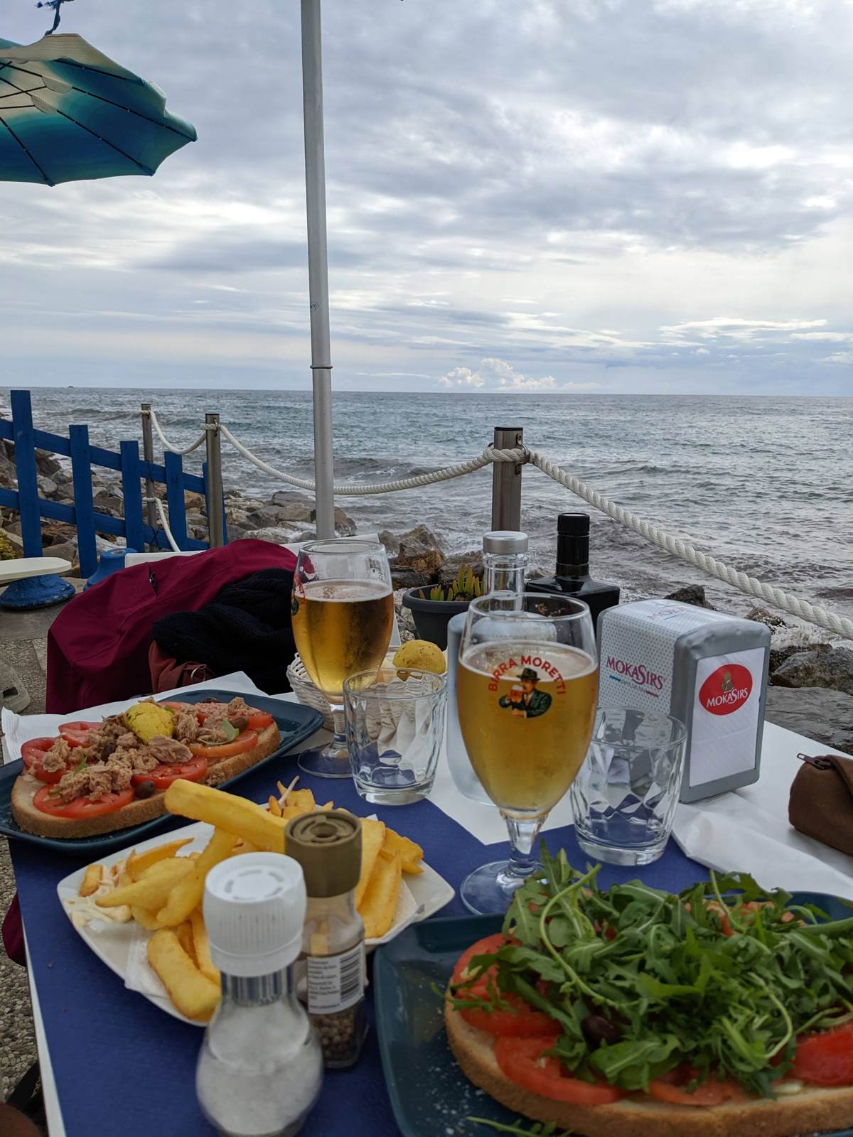 A seafood dinner at a restaurant table overlooking Porto Maurizio harbour